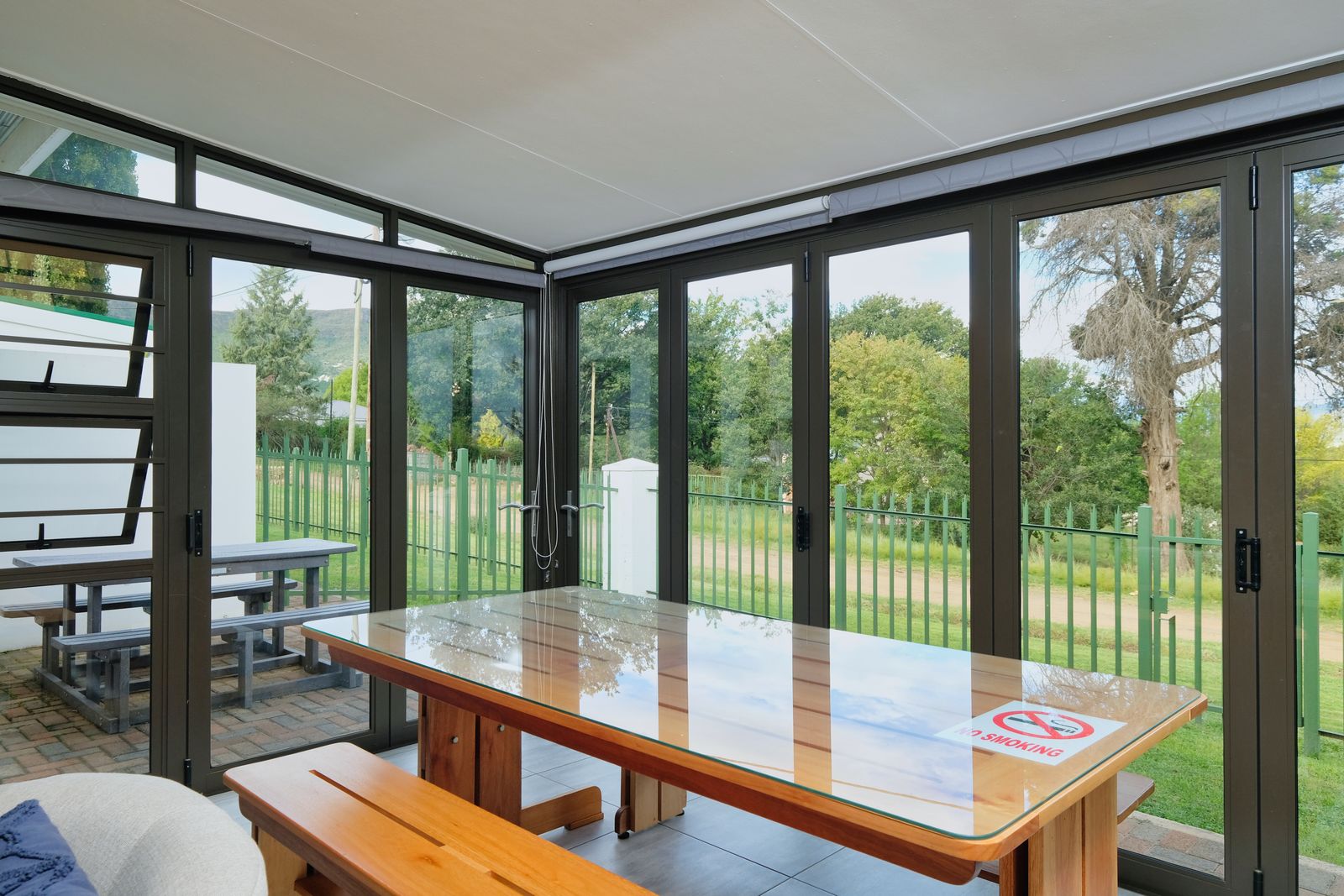 Bright glazed garden room with dark frames